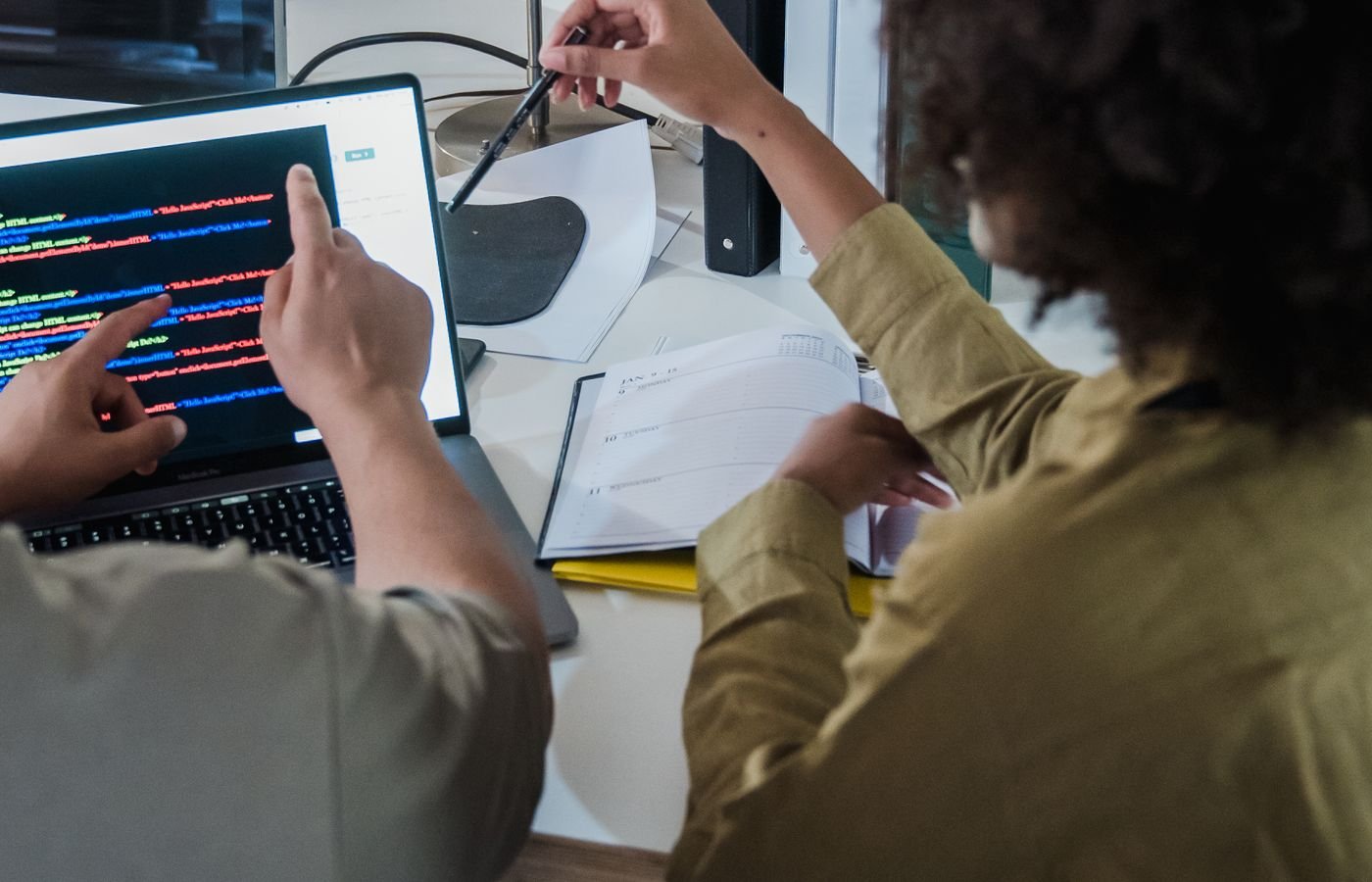 Developers comparing two solutions on screen