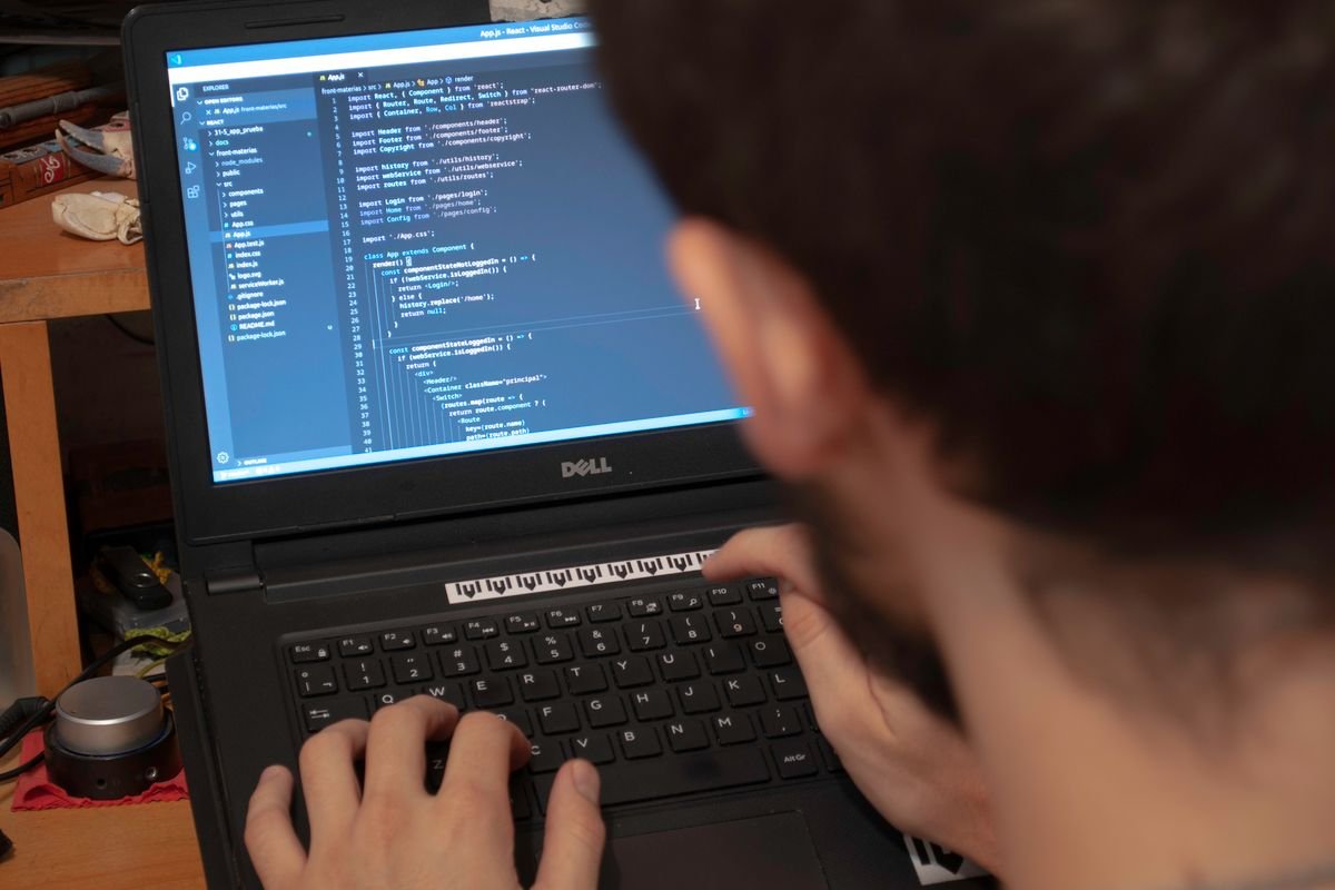 Developer writing HTML and CSS on a laptop screen