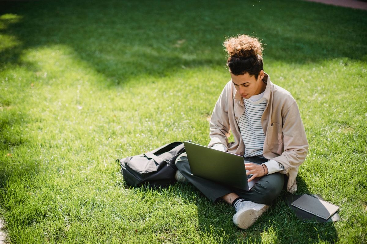 Student watching a recorded programming lesson on a laptop