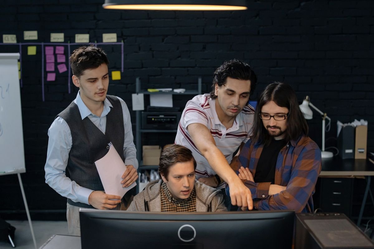 Software team reviewing code together at a desk